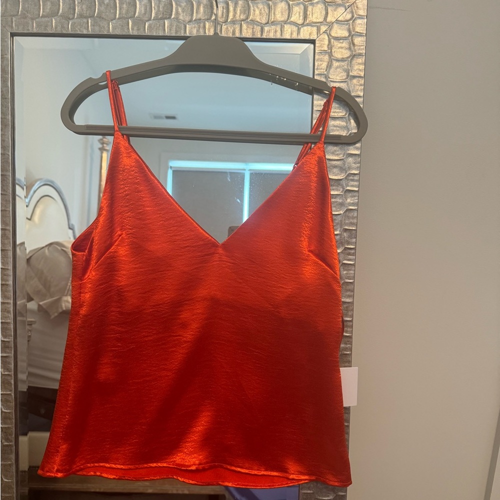 Orange hammered shell; 100% polyester w/ lining.  Perfect alone or under blazer.